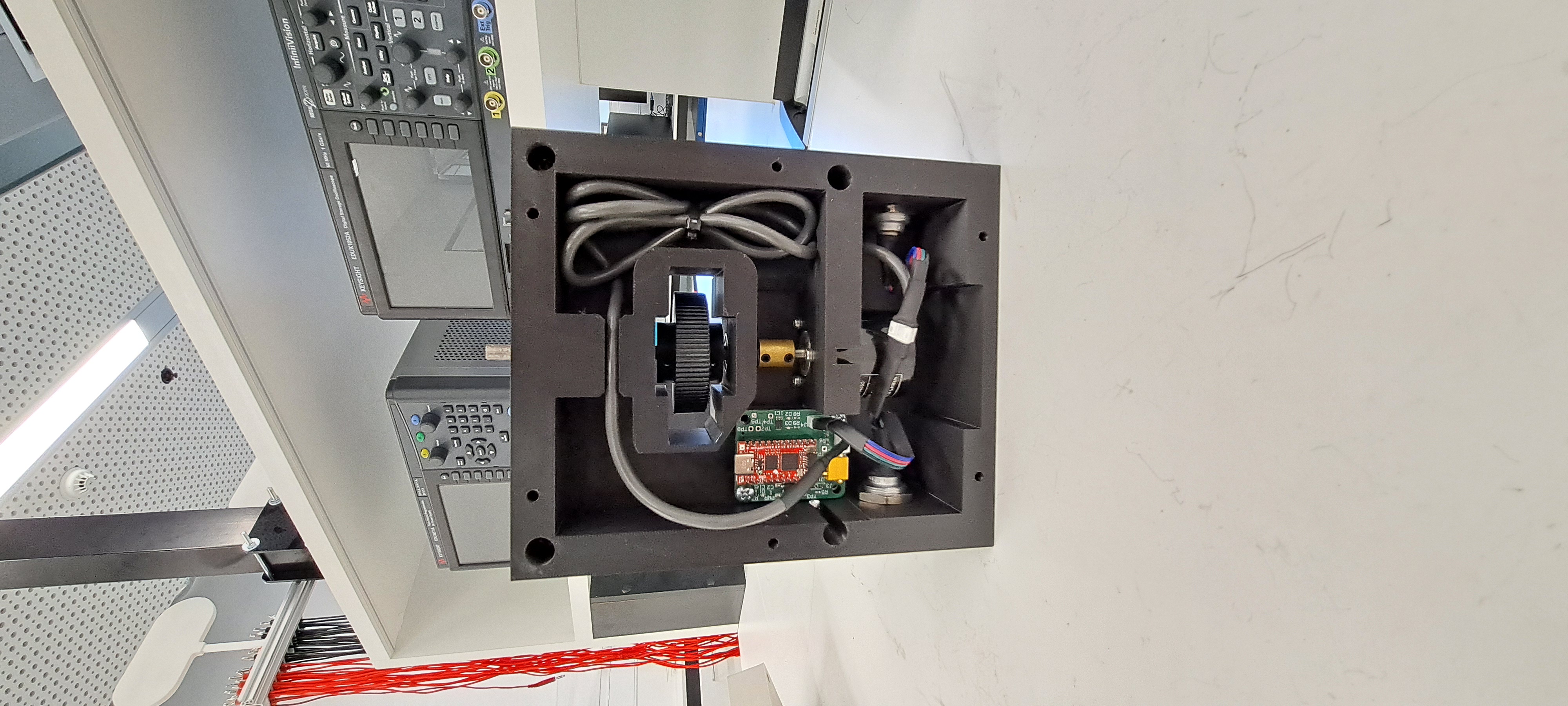 Follower wheel encoder prototype installed inside a black enclosure