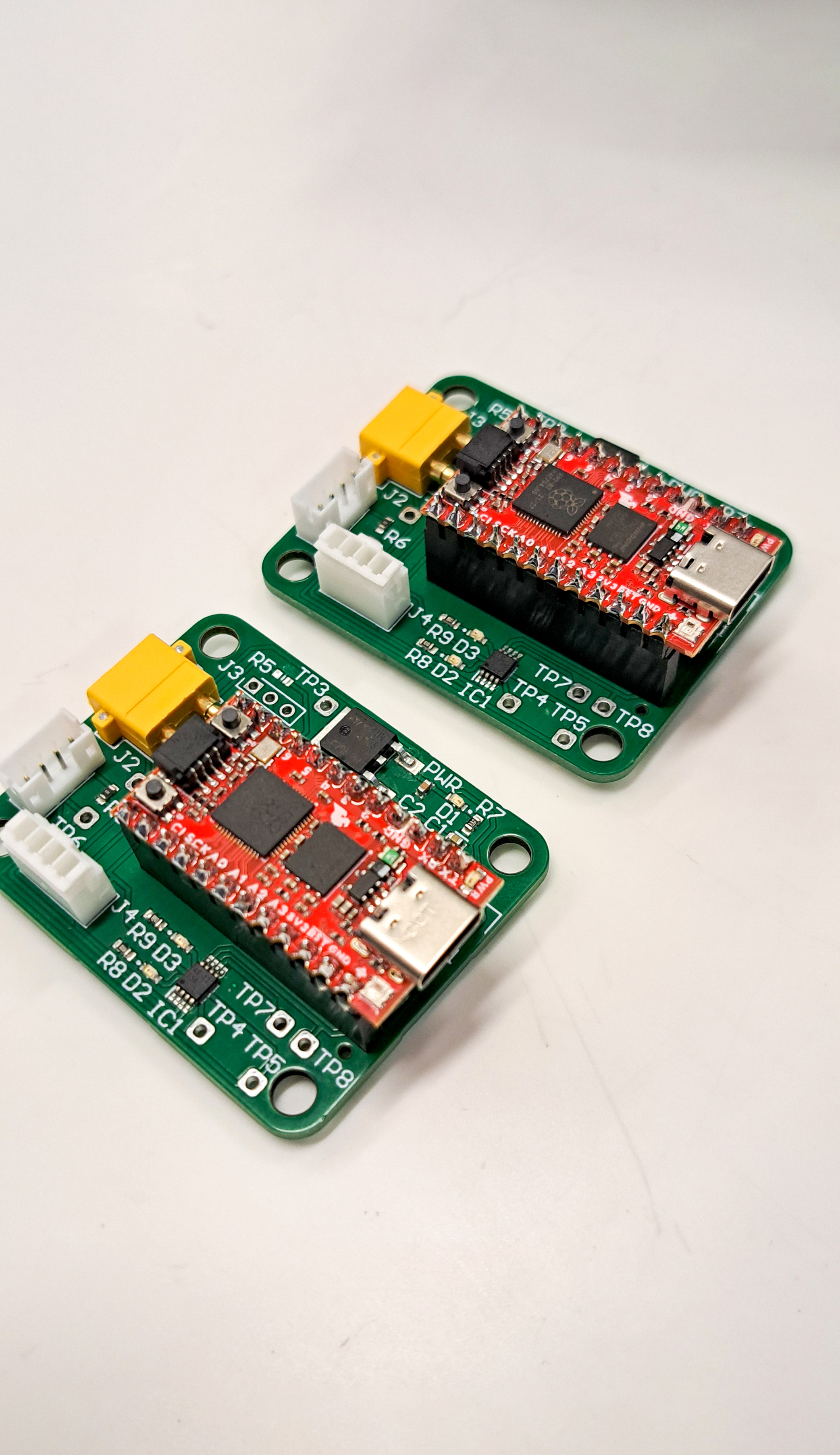 Two assembled Sewer Serpent encoder interface PCBs with RP2040 modules fitted
