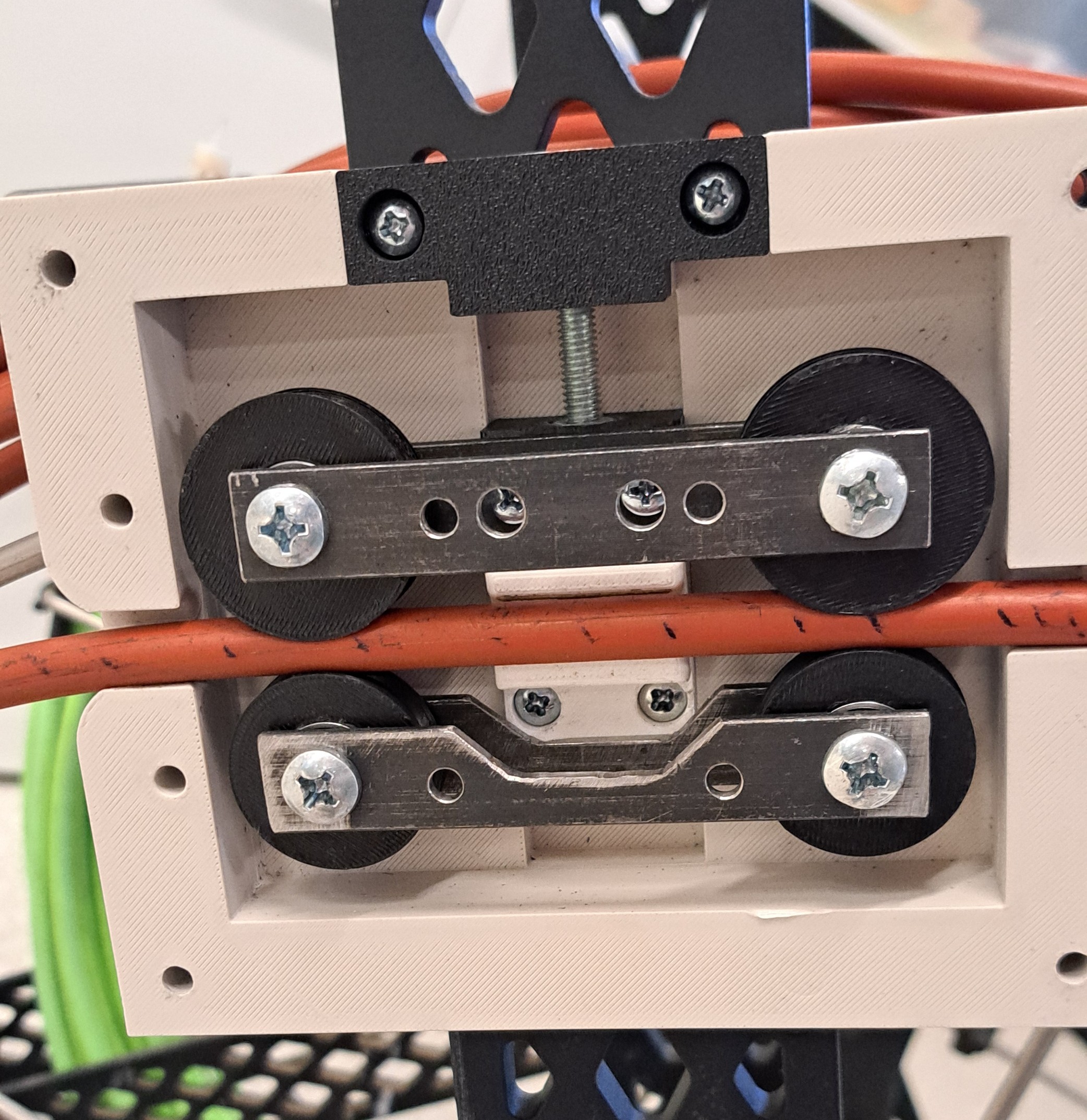 Follower wheel encoder prototype clamped around an orange pushrod